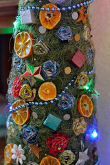 Homemade Christmas tree with, decorations made of paper, Mandarin and electric garland 