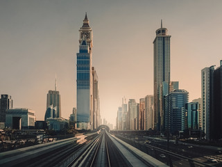 Fototapeta na wymiar Morning in Dubai. City morning landscape with metro line.