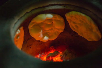 Naan Bread and flame on the hot oven - obrazy, fototapety, plakaty