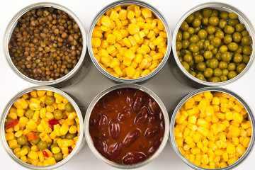 Canned food on white background. Green pea, beans, corn, lentils.