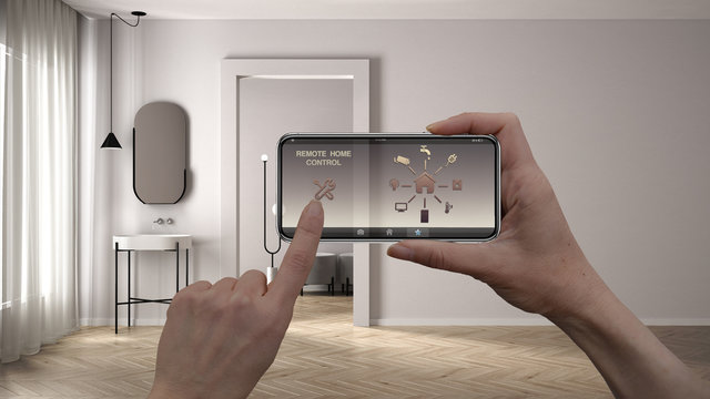 Remote home control system on a digital smart phone tablet. Device with app icons. Bathroom with plaster walls and parquet, empty room with sink and mirror, architecture design