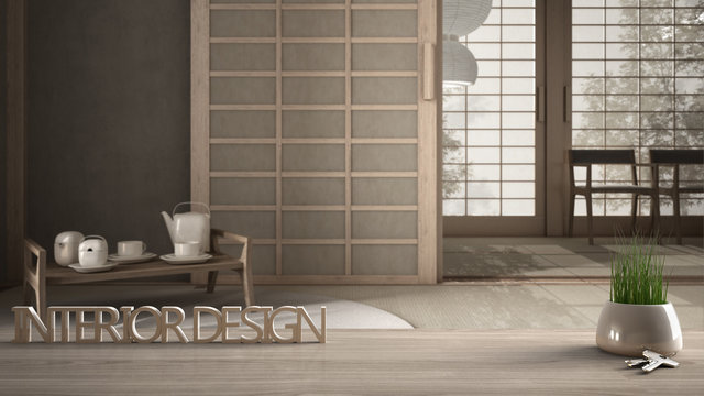 Wooden table, desk or shelf with potted grass plant, house keys and 3D letters making the words interior design, over empty japanese tea-room, project concept copy space background
