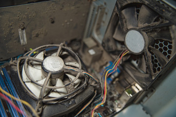 Dust on computer pc processor cooler with mainboard and computer case fragment.
