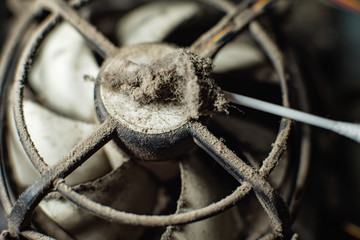Dust on computer pc processor cooler with mainboard and computer case fragment.