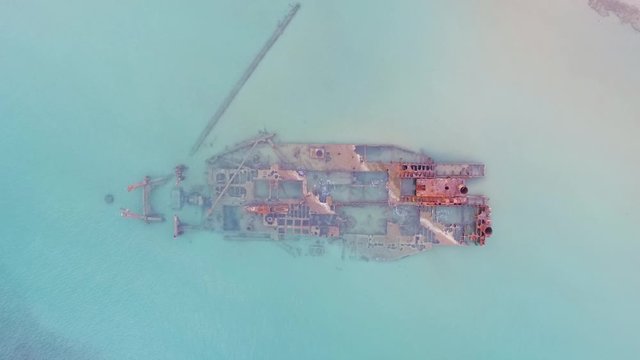 Epanomi Shipwreck national park in Greece - Aerial bird view of shipwreck in turquoise blue sea 