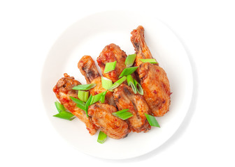 Chicken with teriyaki sauce and green onions. On a white plate. View from above. On white background. Isolated.