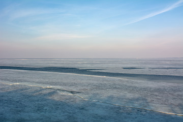 Fototapeta na wymiar Ice covered river on blue sky background in spring