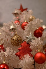 Fototapeta na wymiar White Christmas tree, with red decoration and christmas light