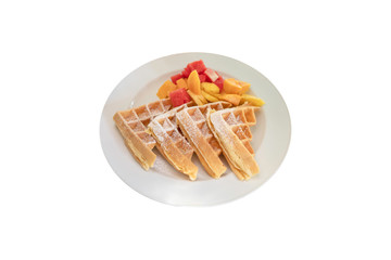 Waffles with mixed fruits, mango, watermelon, pineapple in a white plate on a white isolated background