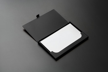 black business card case opened with cards