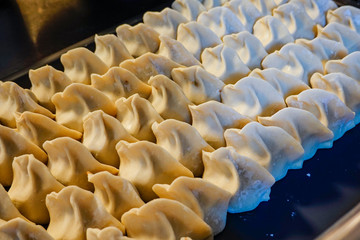 Fototapeta premium Stockholm, Sweden Raw and home-made Chinese dumplings on a tray.