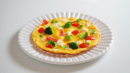 Omelet with broccoli, cheese and tomatoes