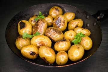 Baked potatoes on frying pan