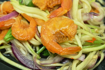 spicy dried shrimp with slice mango fruit salad on plate