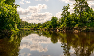 beautiful views of calm water, clouds and tree glare