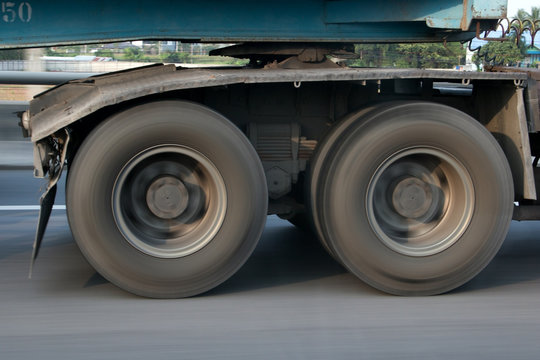 The Spinning Wheel Of A Truck Running On The Road. Detail Of A Rotating Wheel Of A Truck.