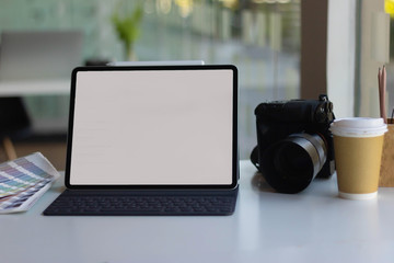 Work space on black table of photographer. Minimal workspace with Laptop, camera and lens copy space on dark background. Modern and elegant. Top view. Flat lay style. Close up.