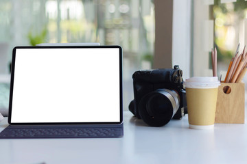 Work space on black table of photographer. Minimal workspace with Laptop, camera and lens copy space on dark background. Modern and elegant. Top view. Flat lay style. Close up.