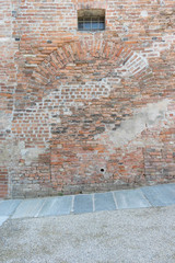Texture of wall with ancient bricks and an arch