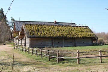 Wooden farm buildings in the Russian village of Mikhailovsky in early spring 2019