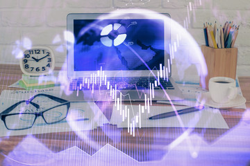 Financial graph colorful drawing and table with computer on background. Double exposure. Concept of international markets.