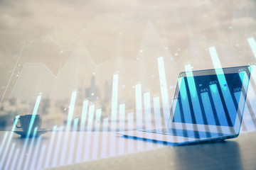 Forex Chart hologram on table with computer background. Multi exposure. Concept of financial markets.