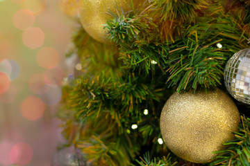Christmas background celebrate decorated Christmas tree with golden sparkle ball above green leaf background