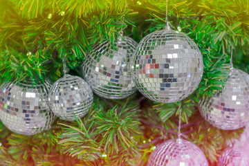 Christmas background celebrate decorated pine Christmas tree with mirror sparkle ball above green leaf background