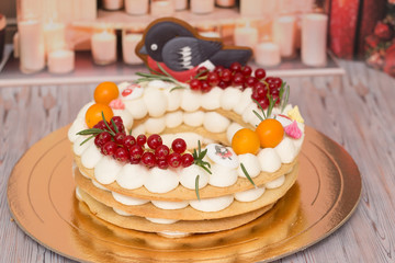 Beautiful birthday cake decorated with decor and fresh berries