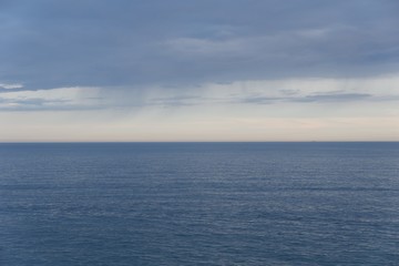 Seascape horizon line with blue cloudy sky. Sunset in Peniscola, Spain