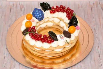 Beautiful birthday cake decorated with decor and fresh berries