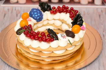 Beautiful birthday cake decorated with decor and fresh berries