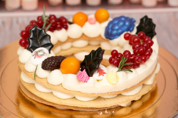 Beautiful birthday cake decorated with decor and fresh berries
