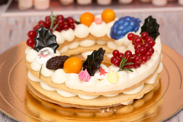 Beautiful birthday cake decorated with decor and fresh berries