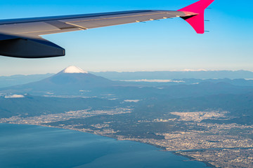 Naklejka na ściany i meble Aerial view of Sagami Bay with Mount Fuji ( Mt. Fuji ) in background and blue sky. Scenery landscapes of the Fuji-Hakone-Izu National Park. Kanagawa Prefecture, Japan