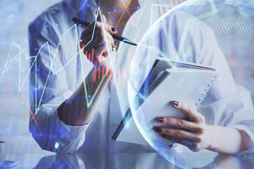 Financial chart drawn over hands taking notes background. Concept of research. Multi exposure