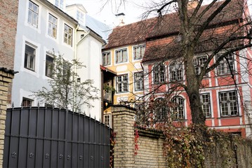 Fototapeta premium Riga, Latvia, November 2019. An enclosed courtyard on the corner of two beautiful old buildings.