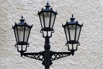 Riga, Latvia,  An interesting old lantern in the Art Nouveau style on a background of a gray wall.