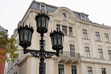Riga, Latvia, November 2019. Beautiful street lamp in the Art Nouveau style on the background of an old house.