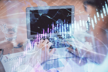 Multi exposure of forex graph with man working on computer on background. Concept of market analysis.