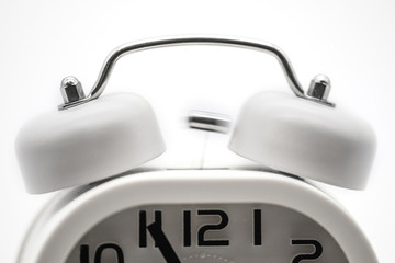 white analog alarm clock