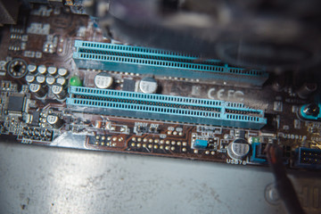 Dust on computer pc processor cooler with mainboard and computer case fragment.