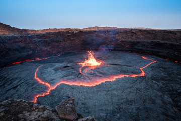 Ripple of lava and sparkling lava at Erta Ale volcano - obrazy, fototapety, plakaty