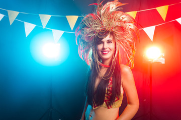Fototapeta na wymiar Holidays, party, dance and nightlife concept - Beautiful woman dressed for carnival night