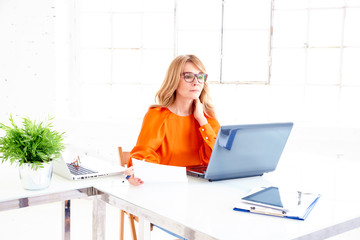 Businesswoman working on laptop at office desk