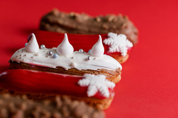 Xmas red eclairs dessert on colorful background