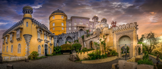 Sintra Pena palace popular destination with dramatic sky during winter sunset in Portugal with...