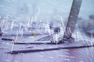 Forex market chart hologram and personal computer background. Multi exposure. Concept of investment.