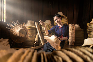 Young women are weaving in field handmade basket of Thailand. - obrazy, fototapety, plakaty