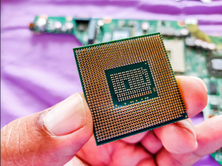 The cpu of the computer is on the hands of a man who is a computer repairman